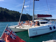 Party aboard our Fontaine Pajot catamaran sailing along the Jersey Coastline
